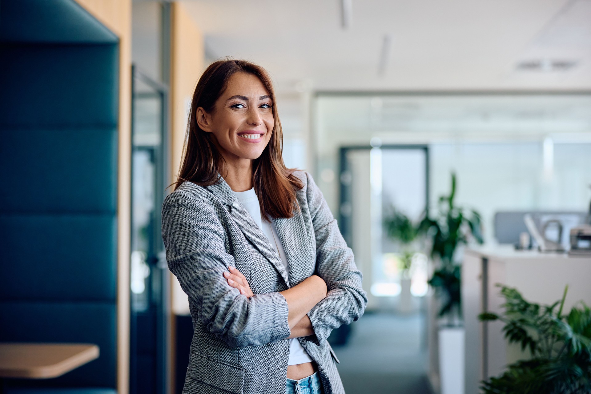 Happy confident businesswoman in the office looking at camera.